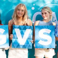 students holding GVSU letters and posing in front of CAB backdrop at Laker Kickoff photo booth